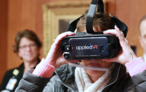 Peggy O'Neil Verronneau tries on applied VR device