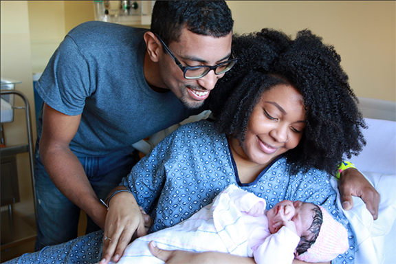 Kelvin and Melissa Alves looking at daughter Khaya Amari Alves at Charlton Memorial Hospital