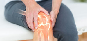 Digitally composite image of man suffering with knee pain