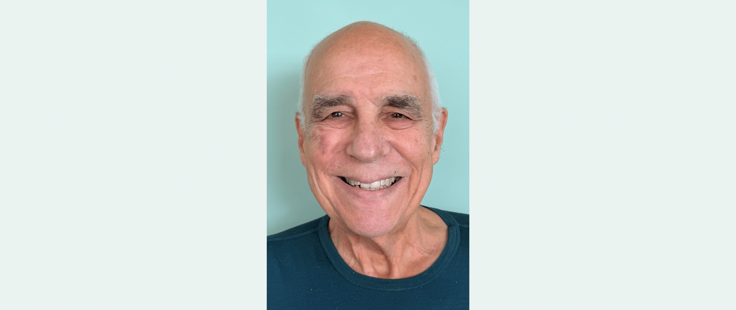 man smiling in a headshot photo